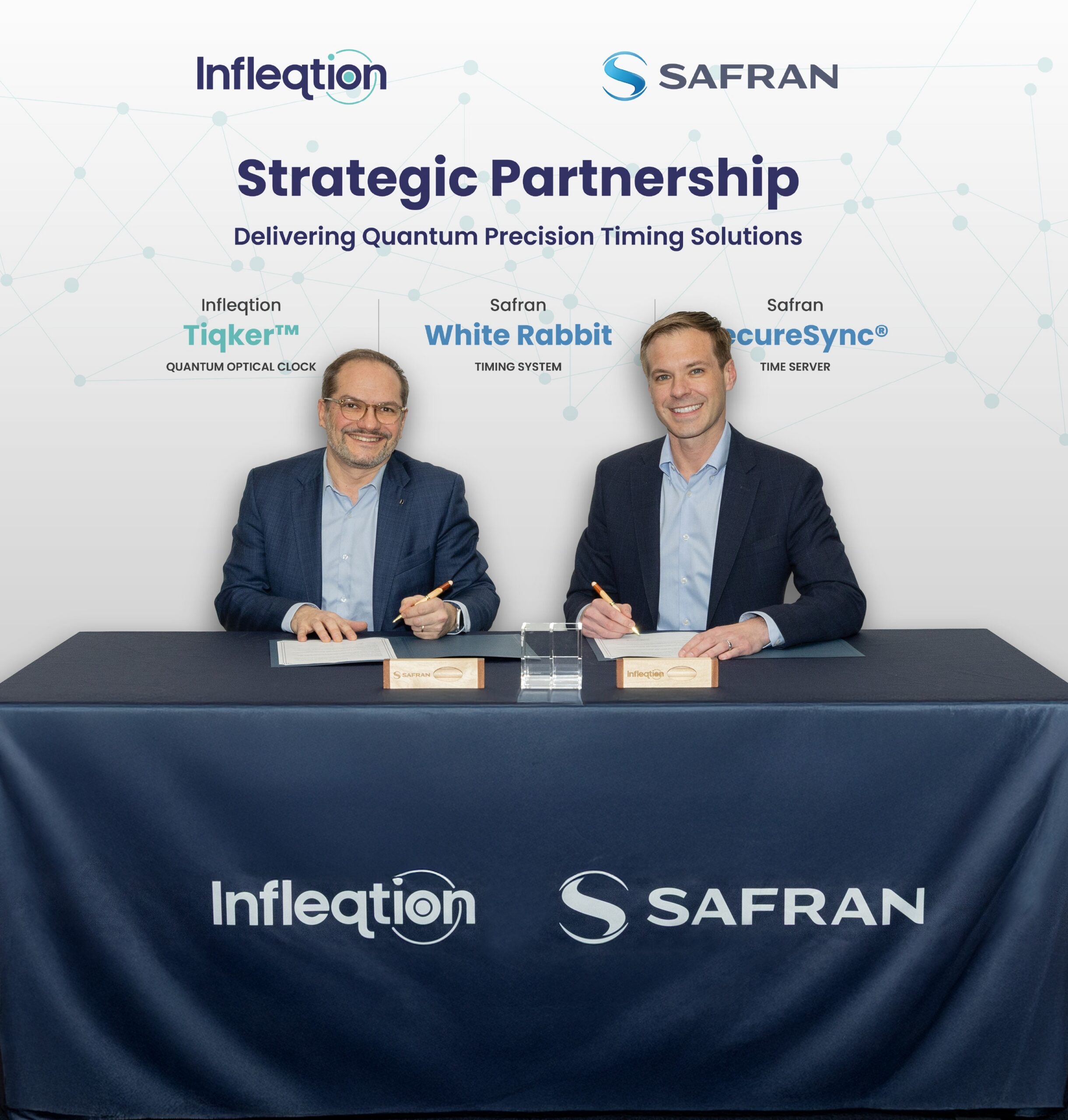 Maxime Gorlier, left, senior vice president and general manager of the One PNT business unit at Safran Electronics & Defense, and Matthew Kinsella, CEO of Infleqtion, sign a strategic partnership agreement.