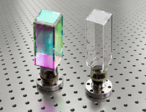 Two glass prisms side by side, one uncoated and one coated, resulting in an iridescent appearance.