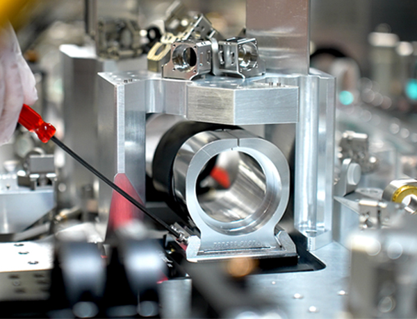 precision optics are fine tuned with a tool on a quantum optical table