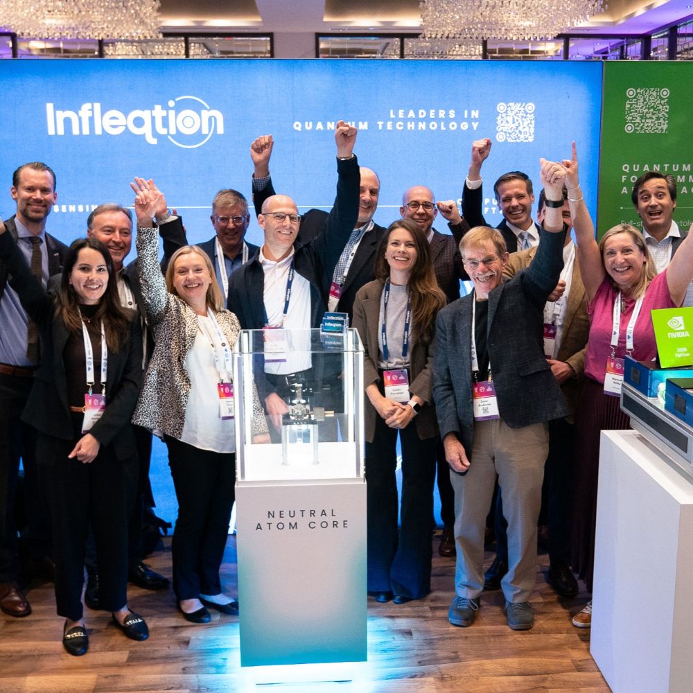Infleqtion team members celebrate at a tradeshow booth