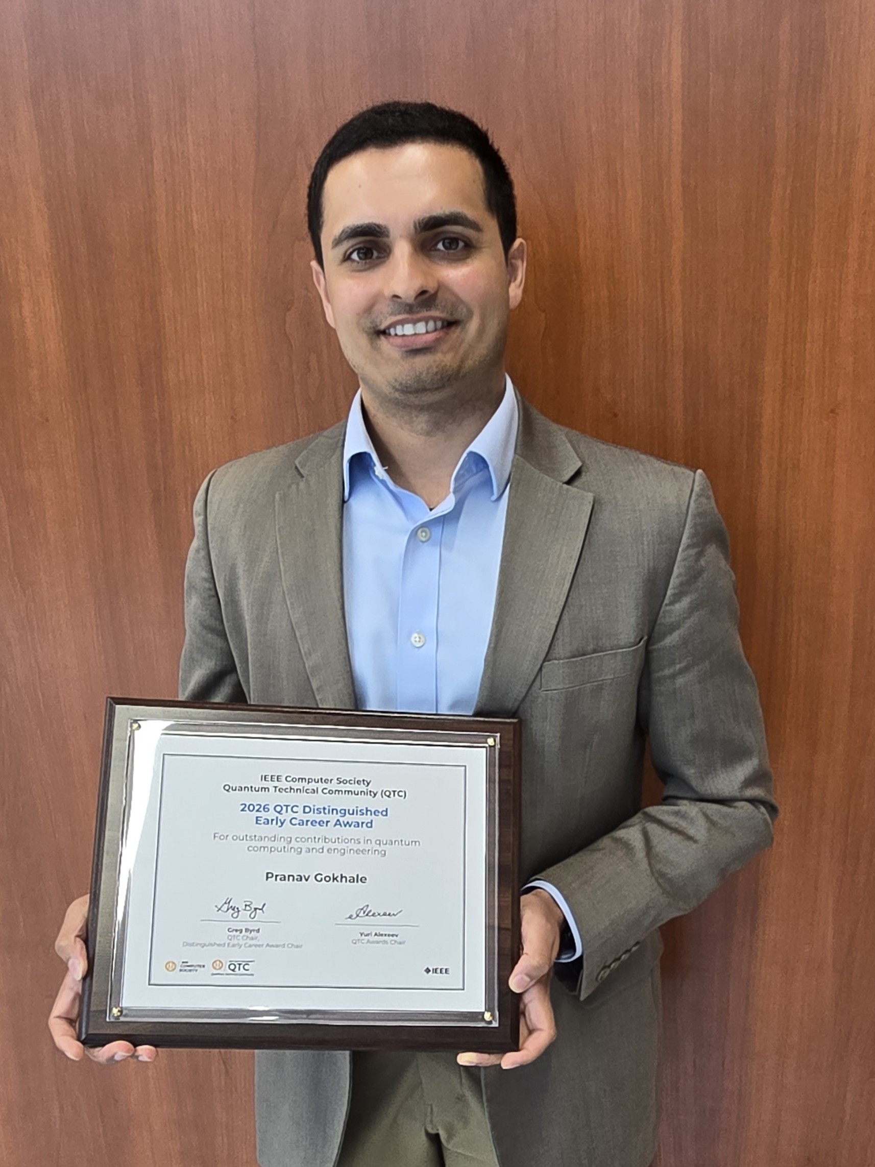Pranav Gokhale holds a framed certificate award