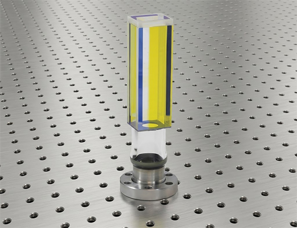 A glass prism coated in a UHV coating, resulting in yellow and blue illumination on the glass.